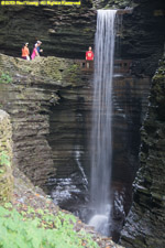 hikers behind waterfall