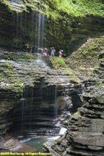 hikers behind waterfalls