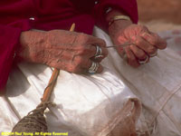 Navajo matriarch spinning wool