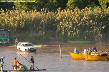 car driving through water to ferry