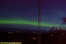 aurora behind tower